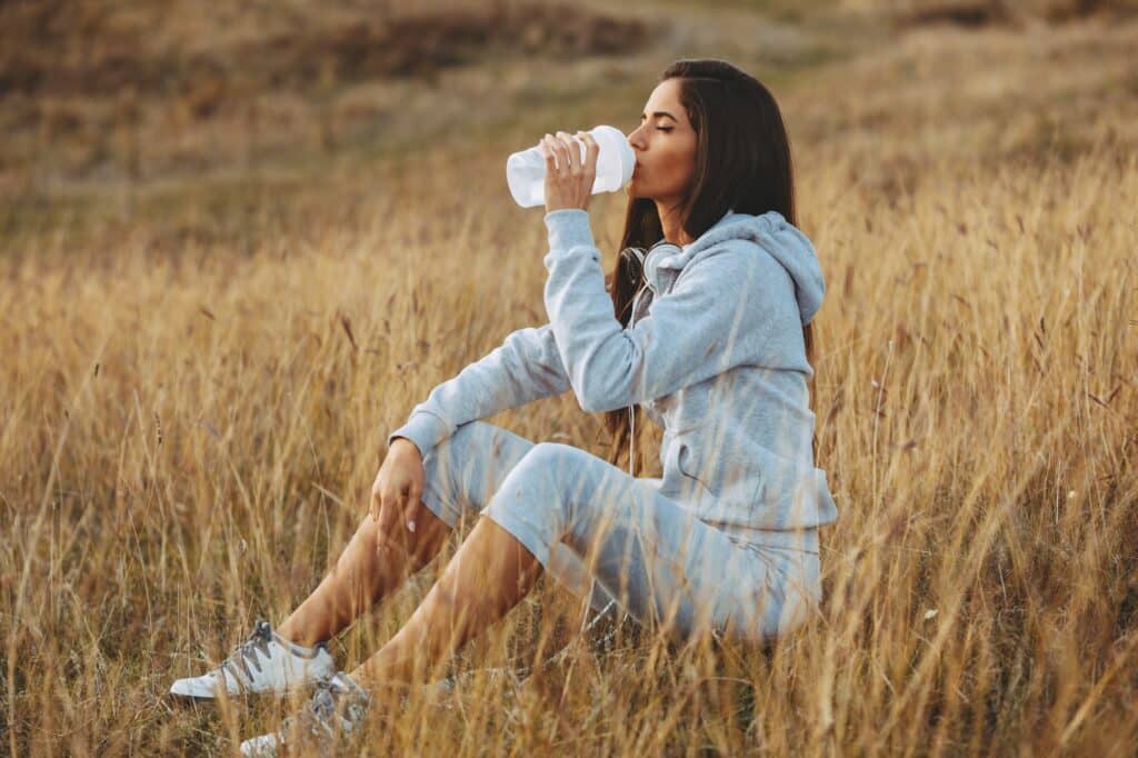 Young women resting after jogging in nature